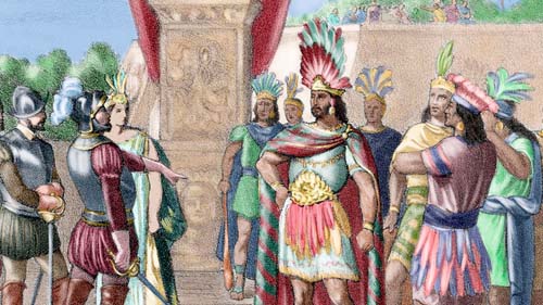 Varias personas vestidas con trajes históricos y tocados coloridos están reunidas en un entorno al aire libre frente a una estructura de piedra.

Descripción generada con IA