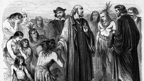 Un grupo de personas vestidas con ropa histórica y tradicional rodean a dos figuras centrales que parecen estar en una conversación seria en un entorno al aire libre.

Descripción generada con IA